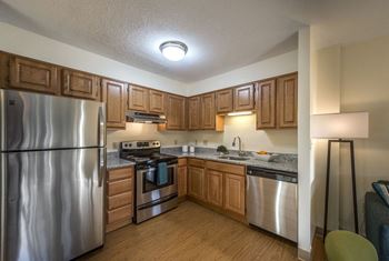 Kitchen with wood cabinets and stainless steel appliances at waterford place.